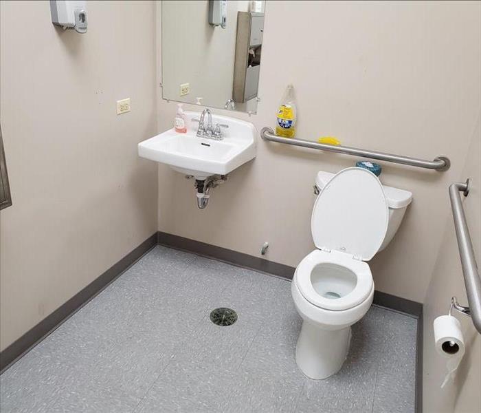 A rebuilt bathroom after sewage water was cleaned up and damaged materials were removed