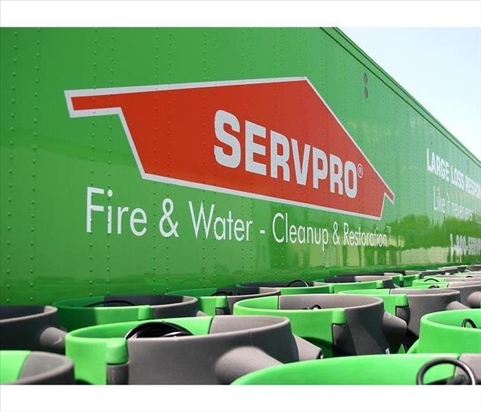 Large green semi with SERVPRO logo, with several green fans lined up in front