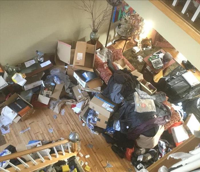 Hoarding house interior with lots of garbage and items sprawled around